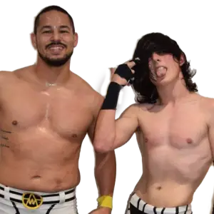 Arron Warnes stands on the left smiling shirtless you can see the waist band of his trousers. Ted Sabine stands on the right with a teped left hand making a pointing motion to his head with his long dark hair covering his eyes.