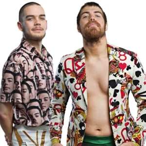 The Badly Dressed Boys Brandon Brooks and Davey Thompson stand together still wearing Brandon wearing his shirt with his face on and Davey his playing card jacket respectively.