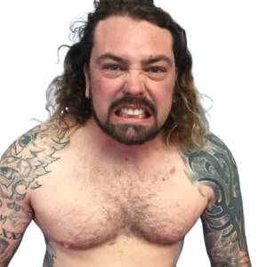 A shirtless Barbarian King with long shoulder length blonde brown hair and a beard. With arms covered in tattoos