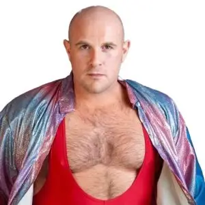 James is wearing a red singlet and a iridescent jacket over his shoulders
