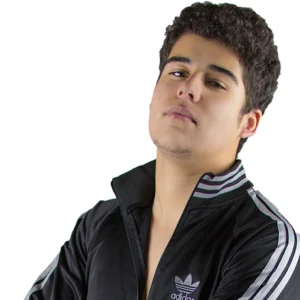 Kid Max stands posed in a black Adidas tracksuit jacket.