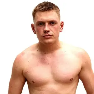 Kai stands a man with short blond hair shirtless