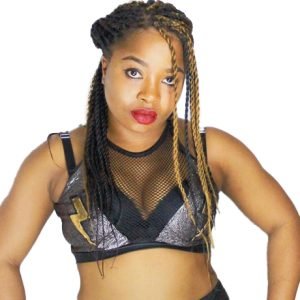 Misha is waring a netted silver top with a gold lightning bolt on the right side of her chest and has black and blond braids.