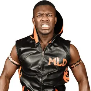 Man Like Deriss puls an agraesive face while wearing a custom black and orange hoodie