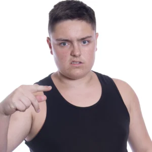 Joey stands wearing a black best top