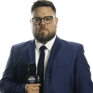 Marty Samuels holding a WIN Microphone while wearing a blue suit jacket